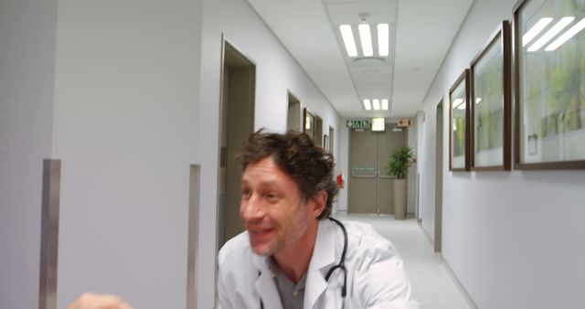 Friendly Doctor Greeting Patient in Hospital Hallway - Download Free Stock Images Pikwizard.com