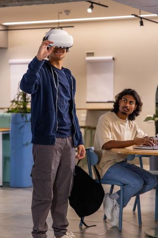Young Multicultural Colleagues Testing Virtual Reality Headset in Modern Coworking Space