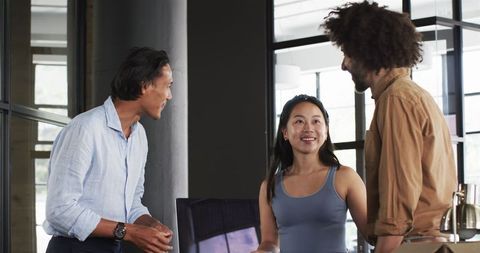 Diverse Colleagues Enjoying Conversation in Modern Office