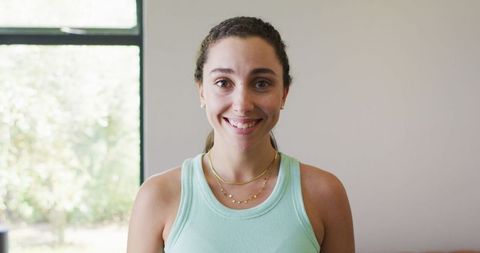 Smiling Woman in Casual Tank Top Relaxing at Home