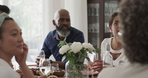 Group enjoying conversation around table at celebration