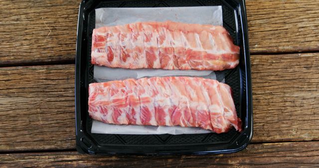 Fresh Pork Ribs on Black Tray Ready for Cooking - Download Free Stock Images Pikwizard.com