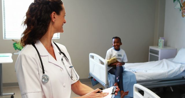 Nurse Smiling and Talking to Young Patient in Hospital Room - Download Free Stock Images Pikwizard.com