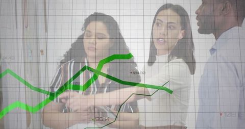 Coworkers collaborating over transparent green financial charts and analytics on glass