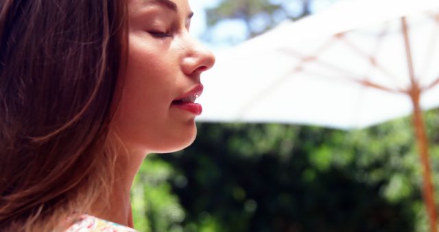 Woman Relaxing Outdoors on a Sunny Day with Eyes Closed - Download Free Stock Images Pikwizard.com