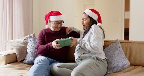 Happy senior father and daughter exchanging holiday gifts