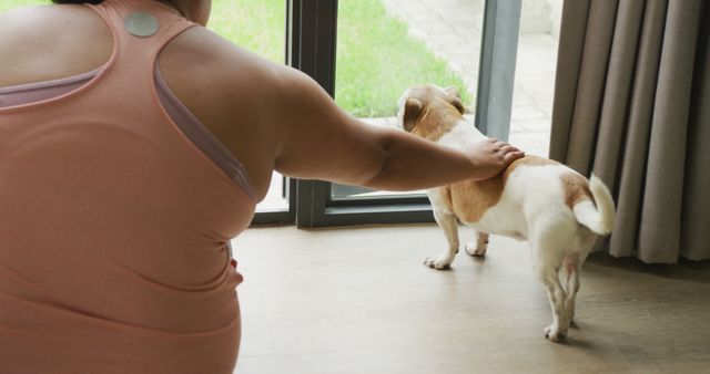 Person with short hair, wearing sleeveless top. Dog facing outdoor. Use for pet care, friendship, human-animal connection themes in lifestyle blogs, advertising, and social media.