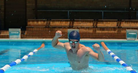 Male Swimmer Celebrating Victory in Pool - Download Free Stock Images Pikwizard.com