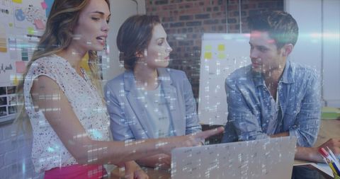 Diverse Colleagues Collaborating on Laptop with Digital Interface Overlay