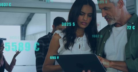 Collaborating Professionals Analyzing Digital Currency at Modern Office