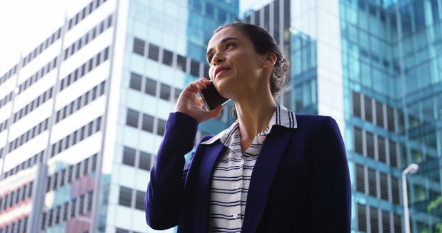 Confident Businesswoman Talking on Smartphone in Urban Area - Download Free Stock Images Pikwizard.com