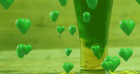 Emerald swirl infusing tall glass with floating green hearts and yellow caps