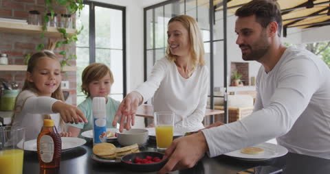 Caucasian Family Enjoying Breakfast Together at Home
