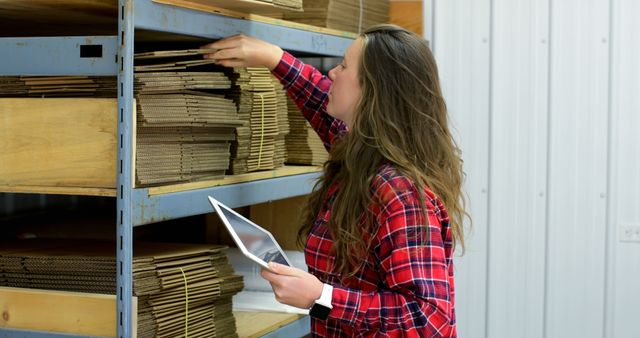 Woman Organizing Cardboard Boxes in Warehouse - Download Free Stock Images Pikwizard.com