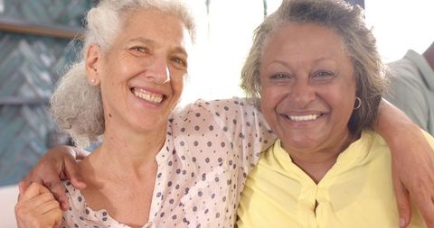 Senior Women Hugging and Laughing, Expressing Joyful Friendship