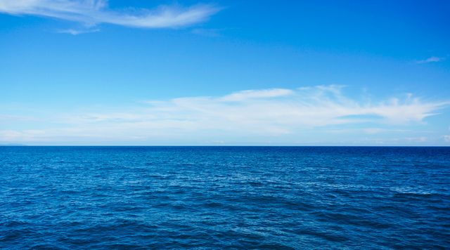 Serene Blue Ocean Under Clear Blue Sky - Download Free Stock Photos Pikwizard.com