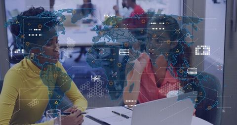 Professional Women Collaborating with Global Data Overlay