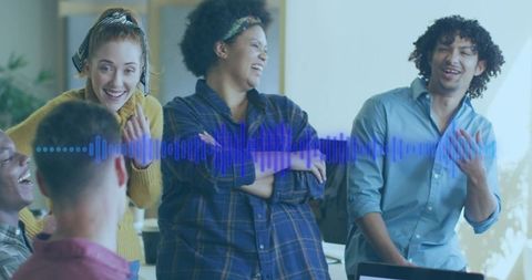 Diverse team collaborating in modern office with audio visualization
