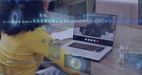 Woman participating in virtual meeting with holographic ar data overlay on laptop