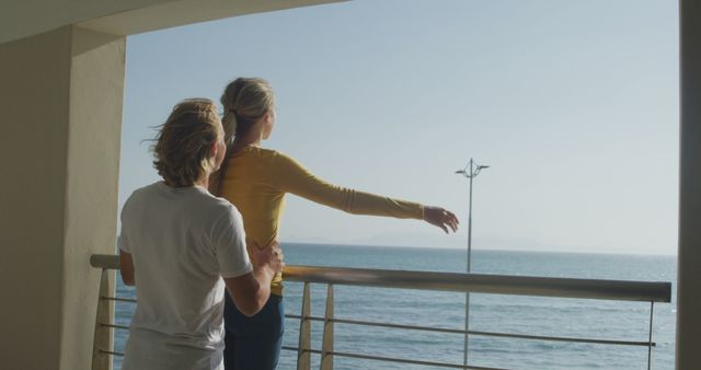 Couple Embracing on Oceanfront Balcony at Sunset - Download Free Stock Images Pikwizard.com