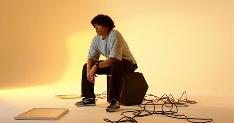 Contemplative man sitting in creative studio space