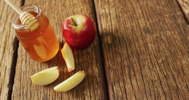 Image of honey in jar and apple and apple slices lying on wooden surface - Download Free Stock Photos Pikwizard.com