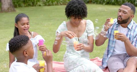 Family Enjoying Day by Blowing Bubbles in Sunny Garden - Download Free Stock Images Pikwizard.com