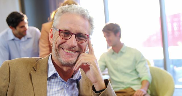 Smiling Mature Businessman in Modern Office Setting - Download Free Stock Images Pikwizard.com