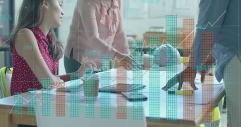 Diverse Architects Analyzing Digital Data with Blueprints in Modern Meeting