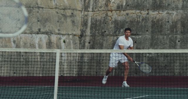 Man Playing Tennis Against Concrete Wall - Download Free Stock Images Pikwizard.com