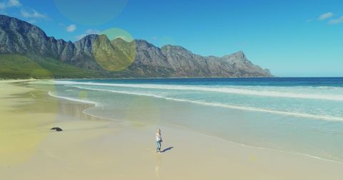 Tranquil Beachside Solo Walk with Mountain Views - Download Free Stock Images Pikwizard.com