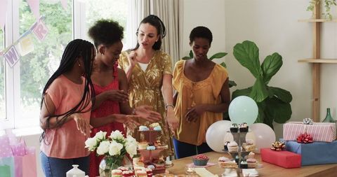 Diverse Friends Celebrating Birthday with Cupcakes and Presents