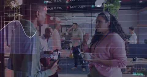 Diverse Colleagues Analyzing Data in Modern Office with Digital Charts Overlay