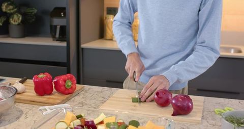 Person preparing fresh vegetables in modern kitchen environment