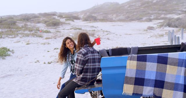 Young Couple Enjoying Beach Outing Together - Download Free Stock Images Pikwizard.com