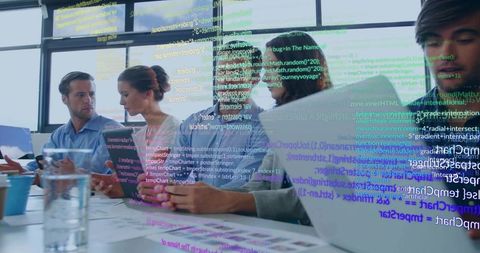 Multidisciplinary team collaborating on ui prototypes and code review in modern workspace