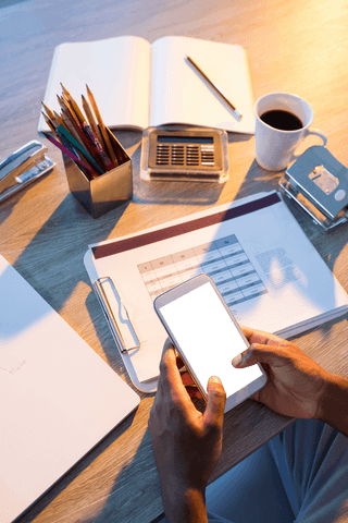 Businessman Holding Transparent Smartphone at Office Desk - Download Free Stock Videos Pikwizard.com