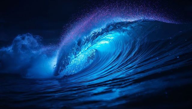 Majestic ocean wave glowing at night, velvety waters and light reflection