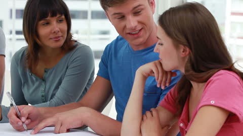 Happy Students Collaborating on Study Project in Bright Room