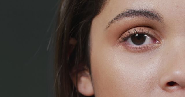 This image captures a close-up view of a woman's face focusing on her eye and smooth skin. It can be used to promote skincare products, beauty routines, and cosmetic services. It is ideal for websites, blogs, and marketing materials related to health and beauty, emphasizing natural beauty and self-care.