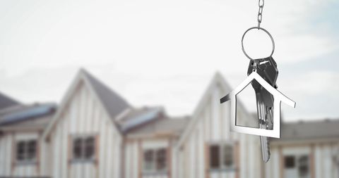 House Keys and Key Fob with Homes in Background