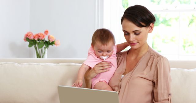 Mother Balancing Work and Child, Using Laptop at Home - Download Free Stock Images Pikwizard.com