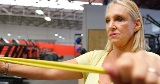 Senior Woman Exercising with Resistance Band in Gym - Download Free Stock Images Pikwizard.com