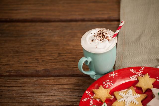 Sweet food and cappuccino on wooden table during christmas time