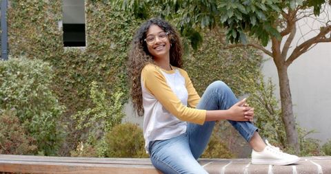 Smiling Teen Girl Relaxing on Ivy-Clad Campus Steps - Download Free Stock Images Pikwizard.com