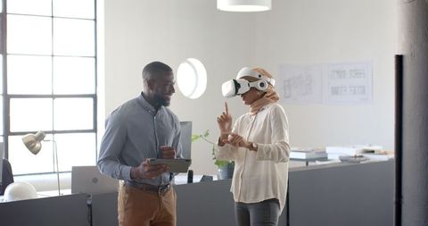 Woman Engaging in Virtual Reality Discussion with Colleague in Modern Office