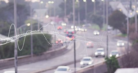 Dusk suburban highway traffic with motion blur and digital waveform overlay