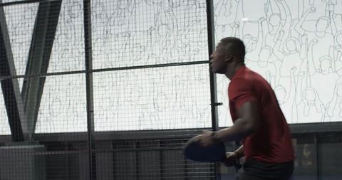 Athletic man engaged in fierce table tennis match on futuristic court