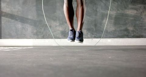 African american athlete jumping rope for cardio fitness workout