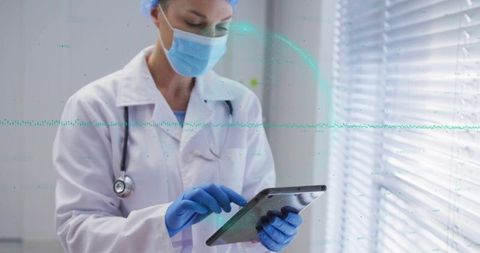 Healthcare Professional Uses Tablet Technology in Modern Clinic